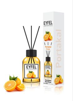 an orange scented diffuser next to its box and some oranges on the table