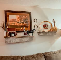 a living room filled with furniture and decor on top of a wall next to a painting