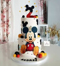 a mickey mouse birthday cake on a table