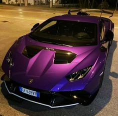 a purple sports car is parked on the street