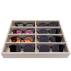 twelve pairs of sunglasses in a display case