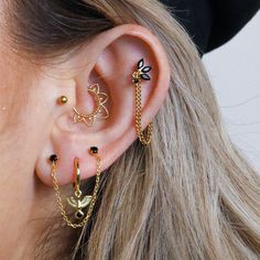 a close up of a person with ear piercings on their ears and behind the ear