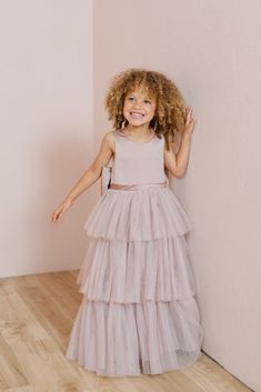 A chic take on a timeless style, our Breely Flower Girl dress is the perfect addition to your wedding line-up! Breely features a modest satin top with a three-tiered tulle skirt creating the perfect dress for your little one to twirl the night away! Breely is finished off with a low v-back and an oversized satin bow. M Tiered Tulle Skirt Dresses For Dress-up, Tiered Tulle Tutu Dress For Dress-up, Tiered Tulle Princess Dress For Dress-up, Confirmation Tulle Princess Dress With Ruffles, Tulle Princess Dress With Ruffles For Confirmation, Confirmation Princess Dress With Tulle Ruffles, Tiered Princess Dress For Wedding, Bridesmaid Tiered Tulle Dress, Tiered Tulle Tutu Dress