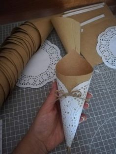 paper cones are wrapped in brown paper and tied with twine on top of doily