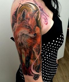 a woman with a tattoo on her arm has a red fox in the middle of it