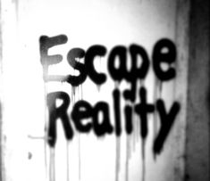 the word escape reality is spray painted on a door with black paint dripping down it