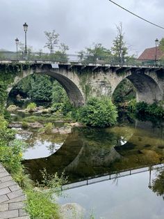 an old stone bridge over a small river