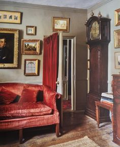 a living room filled with furniture and pictures on the wall