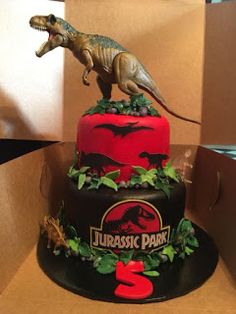 a birthday cake decorated to look like a dinosaur