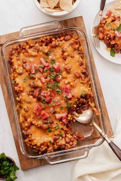 a casserole dish filled with beans, cheese and tortilla chips