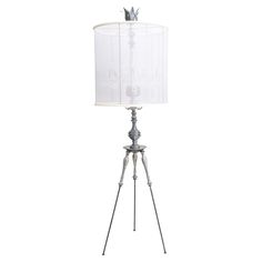 a lamp that is on top of a tripod with a white shade over it