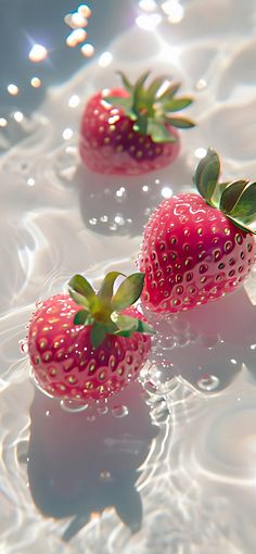 three strawberries floating in the water on a sunny day