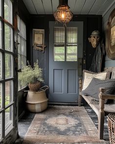 a porch with a bench, potted plants and an old fashioned light hanging from the ceiling