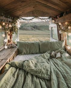 a bed in the back of a truck with lights hanging from it's ceiling