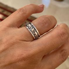 a person's hand with a ring on it