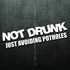 the words not drunk just avoiding potholes are shown in white on a black background