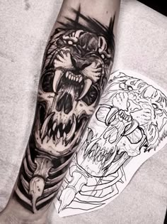 a man's arm with tattoos on it and an animal head in the middle