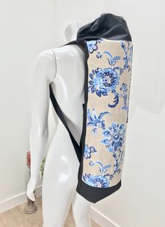 a mannequin wearing a blue and white floral print bag on it's back