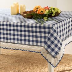 a blue and white checkered tablecloth with flowers on it