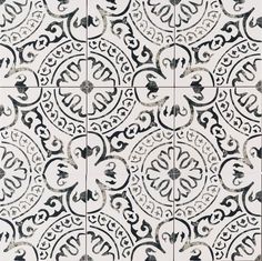 an ornate tile pattern with black and white designs