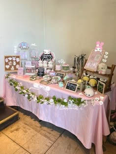 a pink table topped with lots of desserts