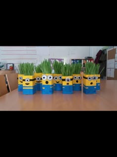 several minion planters sitting on top of a wooden table