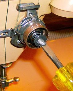 a close up of a sewing machine with a needle in it's center and thread