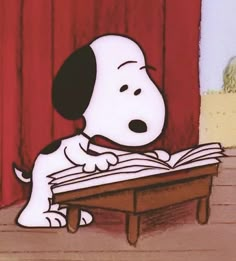 a cartoon dog sitting at a table reading a book