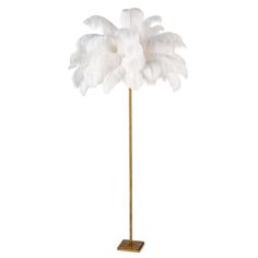 a tall white feathered lamp on a gold base with a square base and metal stand