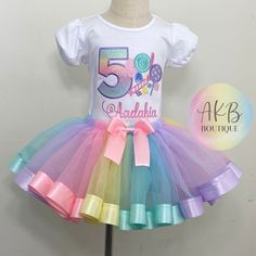 Pastel Candyland theme Custom shirt and matching Ribbon Trim Tutu. Customize it with your  child's age, and name. Ages 1-9 are available.   It is VERY Imortant to match your need by date to the shipping ESTIMATED times. If you need it sooner Please contact me BEFORE purchasing. I also offer 'RUSH ORDERS" there is a separate listing for it and must be purchased with the outfit listing. I offer short and long sleeve shirts. SS = Short Sleeve LS = Long Sleeve I use  Boutique quality shirt for all embroidery. They have PUFF sleeves. They are 100% Combed Cotton SUPER SOFT and run TRUE TO SIZE.  The tutu is made with a soft sheer tulle material and Satin ribbon trim. Elastic for the waistband so the tutu stretches and can fit wider. I use a soft mesh on the backing of the embroidered design to m Candy Theme Outfit, Candyland Theme, Ribbon Trim Tutu, Candy Birthday, Candyland Birthday, Tulle Material, Tutu Outfits, Custom Shirt, Ribbon Trim