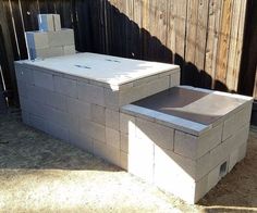 an outdoor fire pit made out of cinder blocks