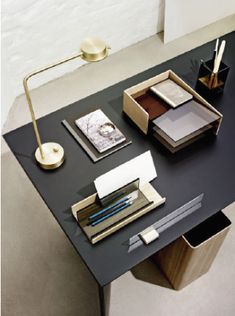 a desk with various items on it including pens, papers and pencils in boxes