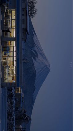 an aerial view of a building with snow on the ground