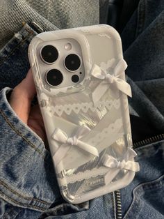 an iphone case with bows on it in someone's jeans and denim jacket,