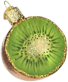 a kiwi ornament hanging from a christmas tree on a white background with gold glitters