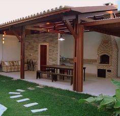 an outdoor living area with patio furniture and stone fireplace