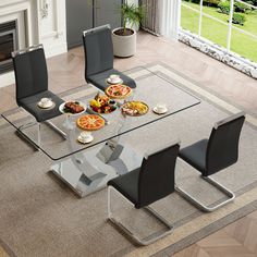 a glass dining table with black chairs and pizzas on the plate in front of it