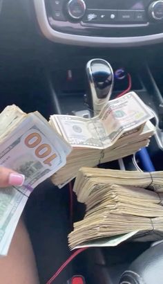 a person is holding money in their car