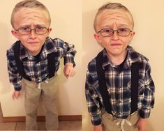 two young boys wearing glasses and suspenders are standing in front of a white wall