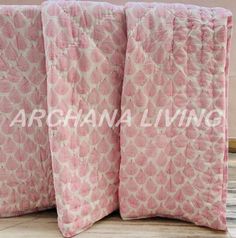 two pink pillows sitting next to each other