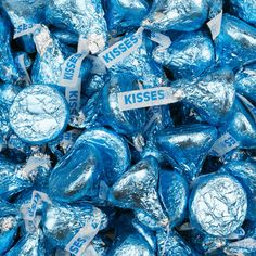 a pile of blue herss wrapped in foil and labeled kiss me on the side