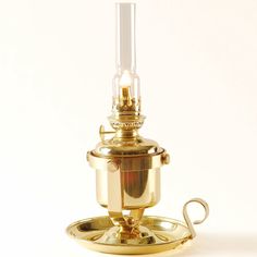 an antique brass oil lamp on a white background