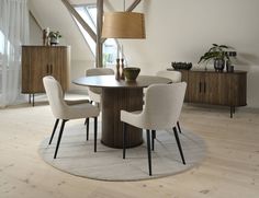 a round table with chairs around it in a room