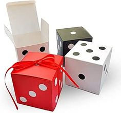 three dices tied with a red ribbon and sitting next to each other on a white surface