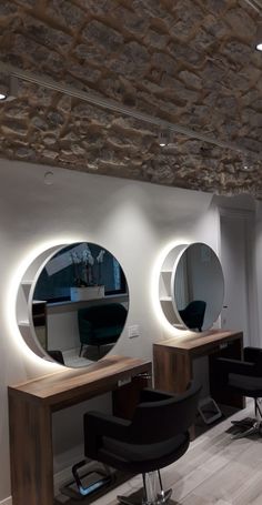 there are three round mirrors on the wall in this hairdressers salon room