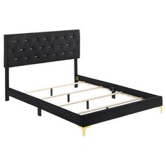 a black bed frame with gold legs and buttons on the headboard, against a white background