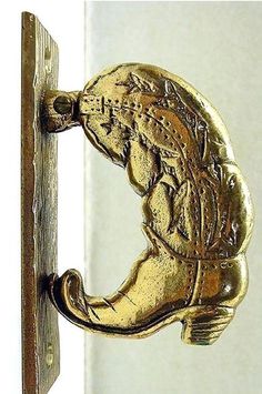 an antique brass door handle with a horse head on it