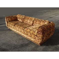 a couch sitting on top of a parking lot