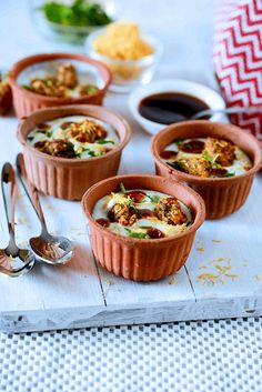 four small cups filled with food sitting on top of a table