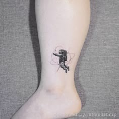 a person with a small tattoo on their foot that has an image of a bee flying through the air